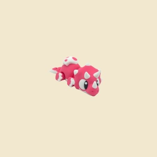 Pinke Triceratops-Miniatur mit weißen Hörnern in Seitenansicht.